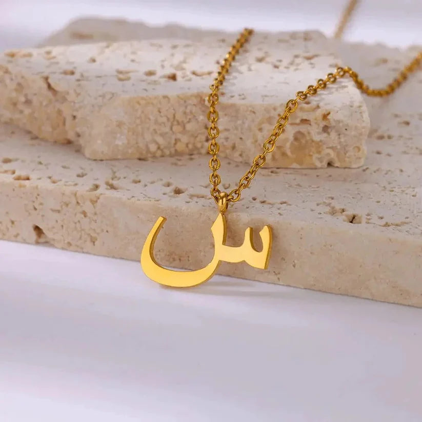 Gold Arabic Initial Necklace featuring a personalized Arabic letter pendant with a timeless elegant finish.