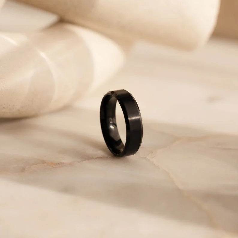 Black ring on a beige marble surface