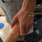 Couple holding hands wearing matching Morse Code Bracelets with personalized name engraving, a minimalist jewelry design for everyday wear.