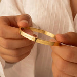 Custom engraved bangle featuring a personalized message on a polished band