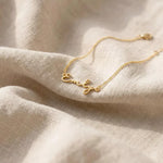 Golden  Chain Bracelet on beige fabric