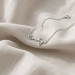 Personalized silver name necklace with a custom script pendant on a delicate chain.