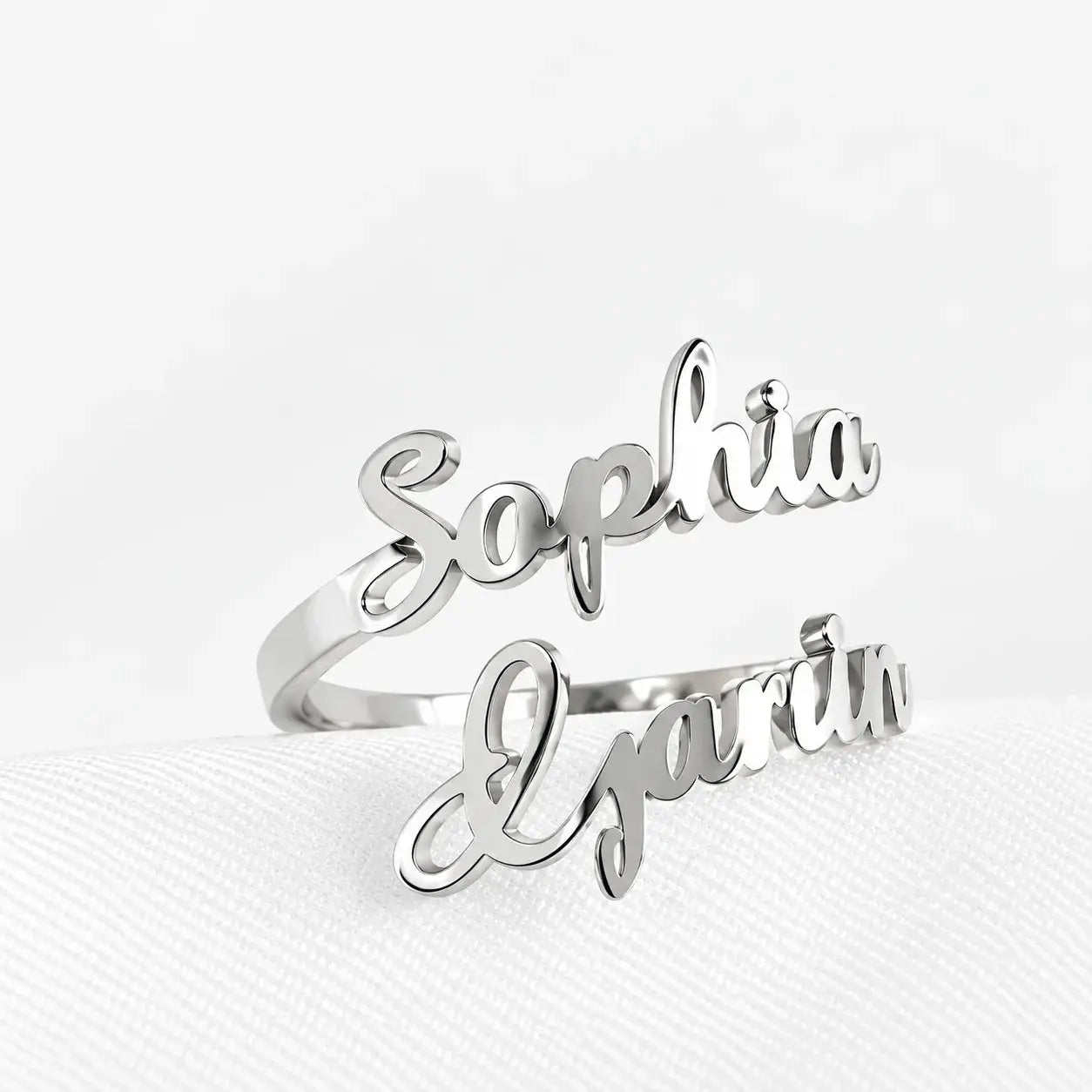 Silver bypass ring with Sophia and Gavin custom script names on textured white background