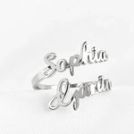 Silver bypass ring with Sophia and Gavin custom script names on textured white background