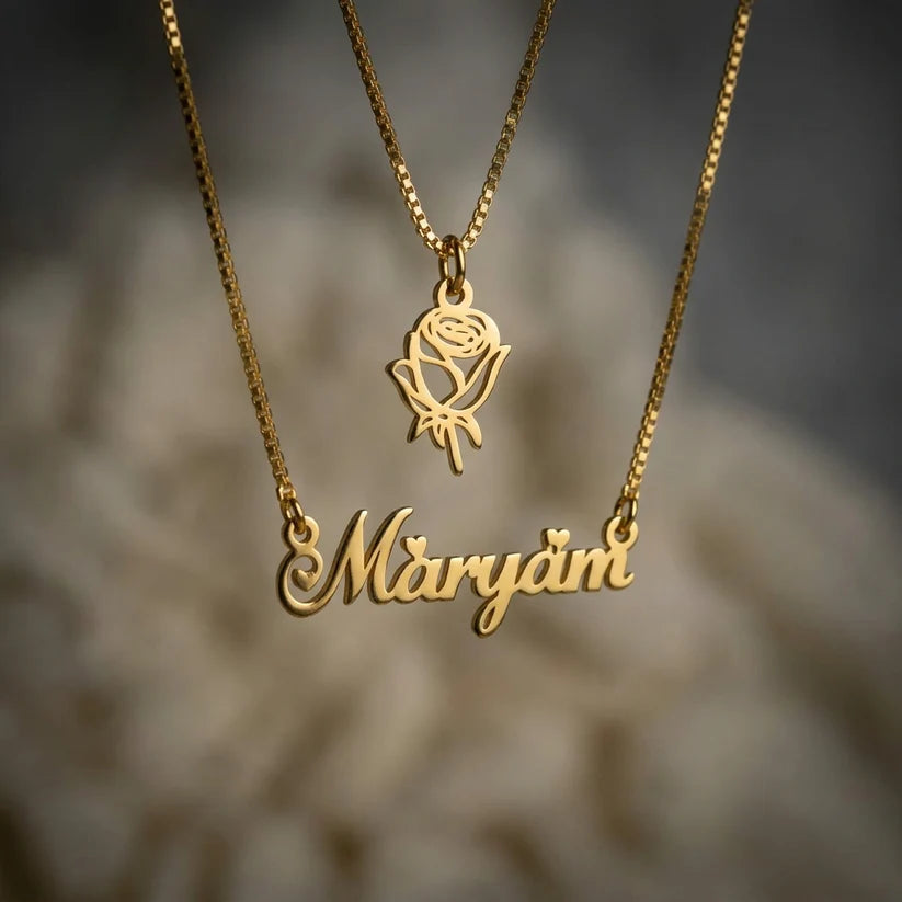 Double Chain Rose Name Necklace in gold featuring a personalised script name necklace paired with a delicate rose pendant on layered chains.