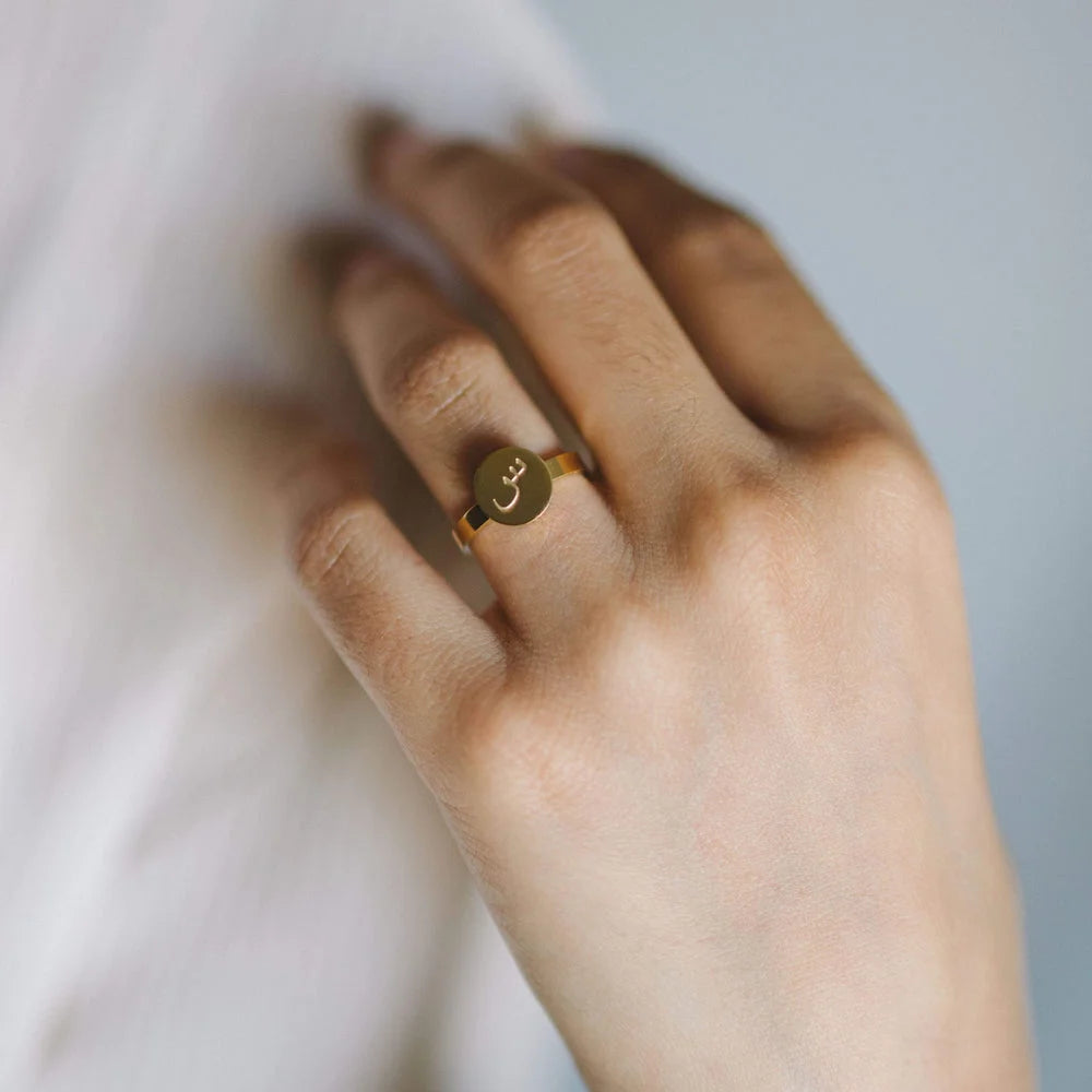 Customized gold disc signet ring engraved with Arabic letter Seen worn on hand