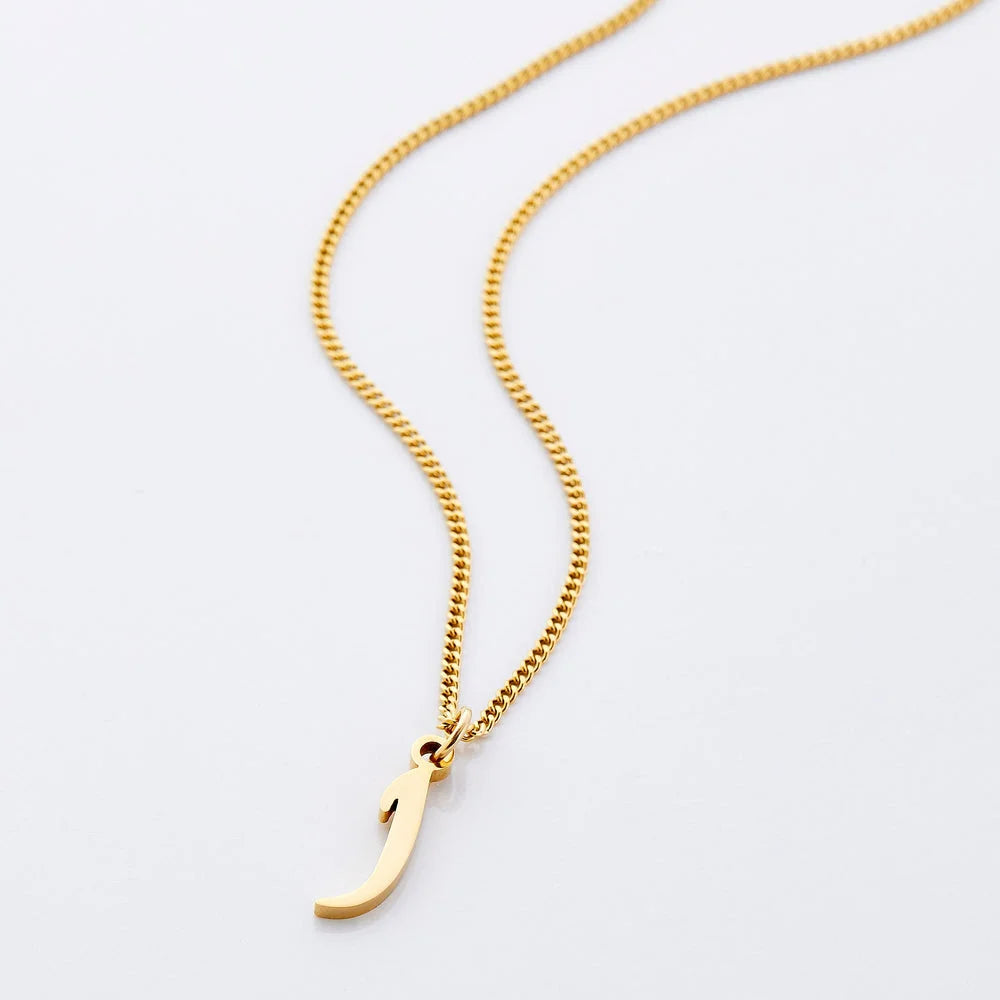 Gold Arabic initial letter charm attached to a fine curb chain against a clean white backdrop.