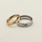 Gold and silver pinky promise rings featuring matching engraved hand gesture designs