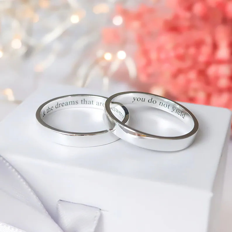 Custom engraved 3mm silver rings with personalised messages inside, shown as matching minimalist bands for couples.