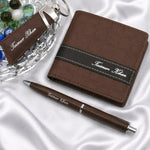 Personalized brown leather wallet with matching pen and keychain gift set featuring custom name detailing