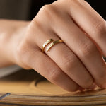 Personalized gold open ring engraved with Emma and Lucas on a finger