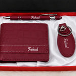 Maroon wallet, matching keychain and pen arranged in a white satin-lined gift box with Fahad personalization