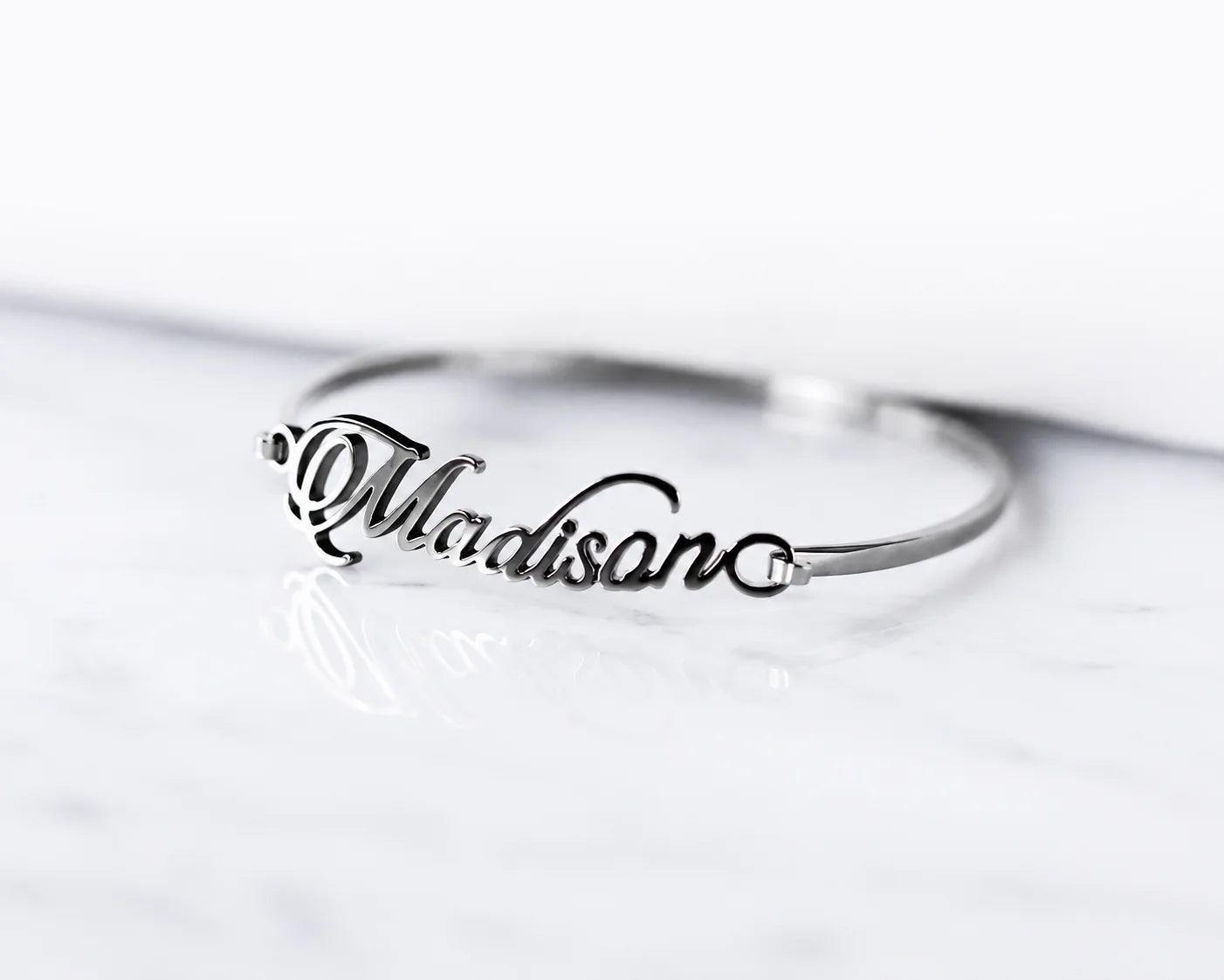 Personalized silver name bracelet featuring a custom script name on a sleek minimalist bangle.