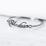 Personalized silver name bracelet featuring a custom script name on a sleek minimalist bangle.