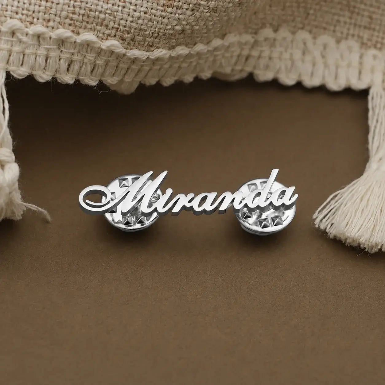 Personalized silver name pin featuring a custom script name in a sleek minimalist design.
