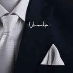 Personalized silver name lapel pin attached to a formal suit jacket.