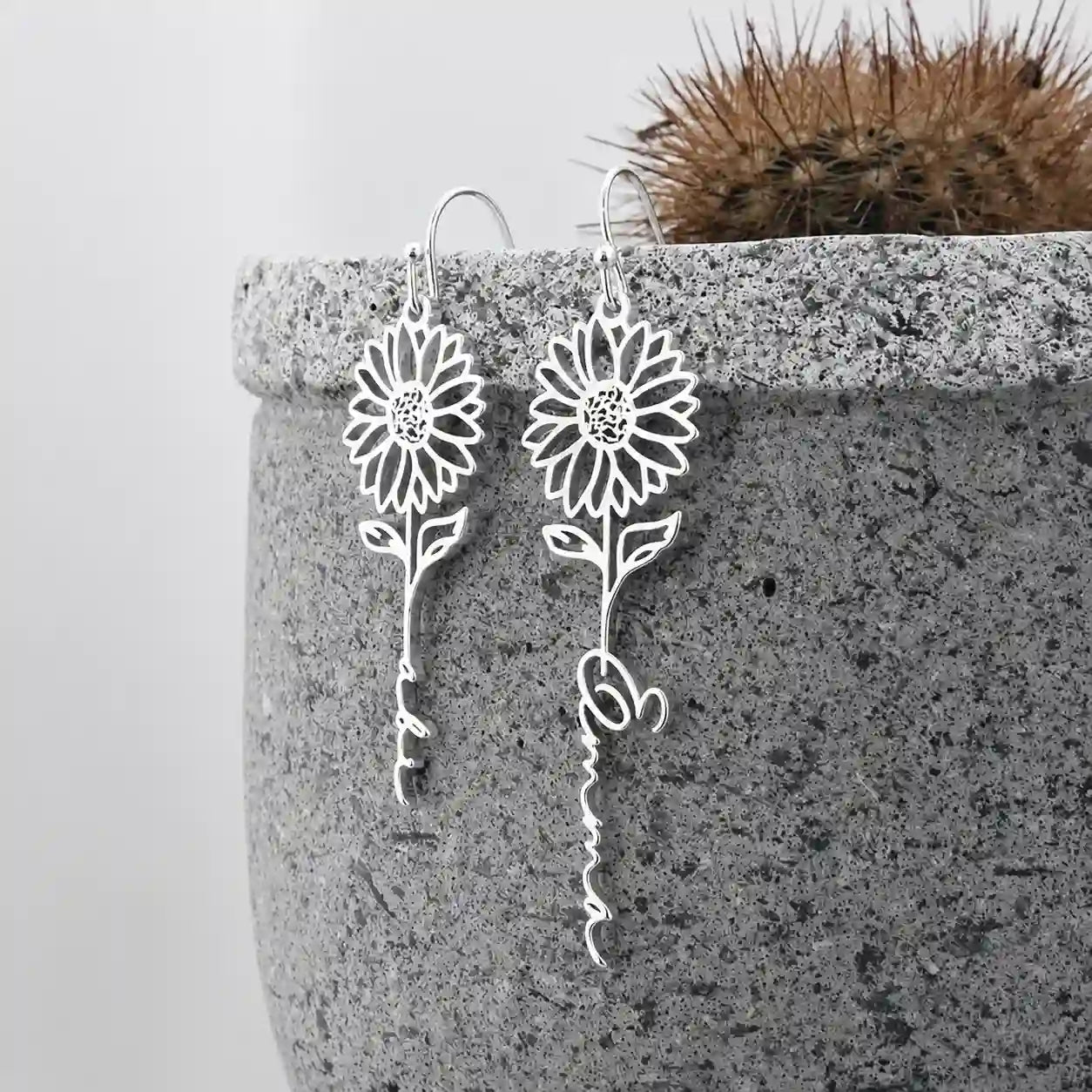 Personalized silver sunflower name earrings with custom script lettering and floral design.