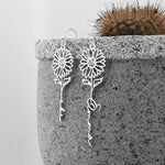 Personalized silver sunflower name earrings with custom script lettering and floral design.