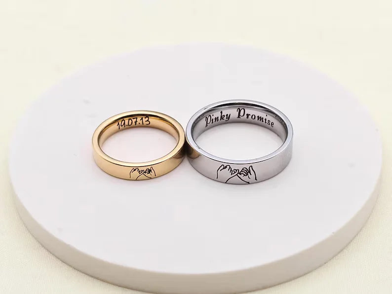 Pink Promise couple rings with interlocking pinky promise hand engraving and date detail