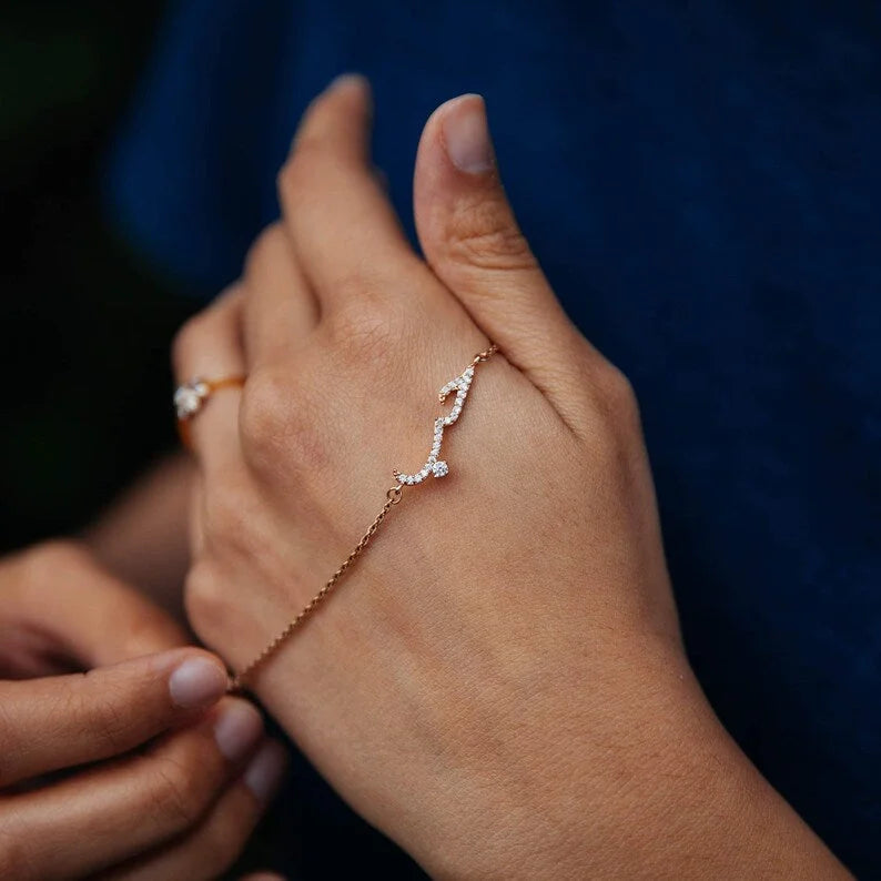 Delicate gold chain bracelet featuring Arabic word Hubb studded with micro pave cubic zirconia stones