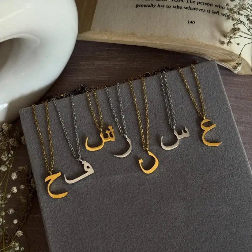 Arabic Initial Necklace Collection in Gold and Silver featuring personalized Arabic letter pendants for everyday wear.
